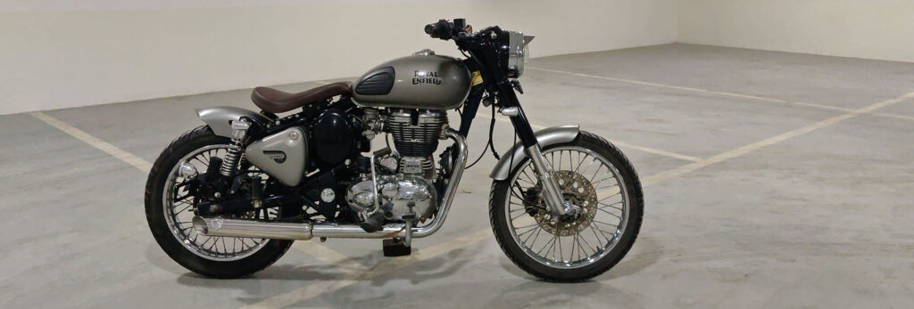 oyal Enfield Classic 350 Bobber custom build by JD Customs, vintage style, single seat, chrome Why this works: It describes the image for screen readers and search engines, specifying it's a custom build and highlighting key visual elements.